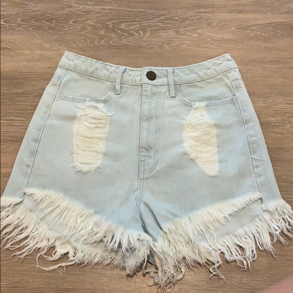 Show Me Your Mumu light wash denim shorts.